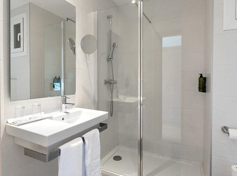 Bathroom with a shower, washbasin and natural light.