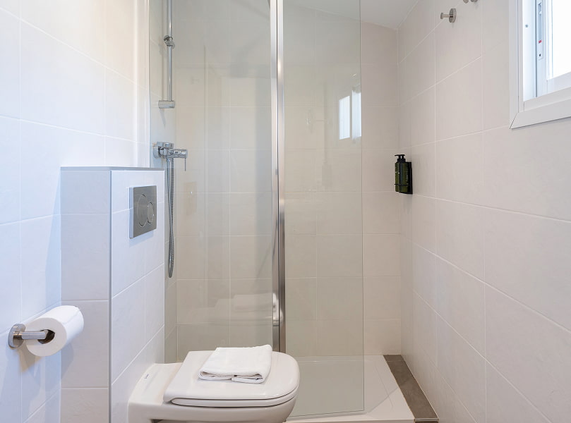 Bathroom with a glass shower cubicle and a toilet